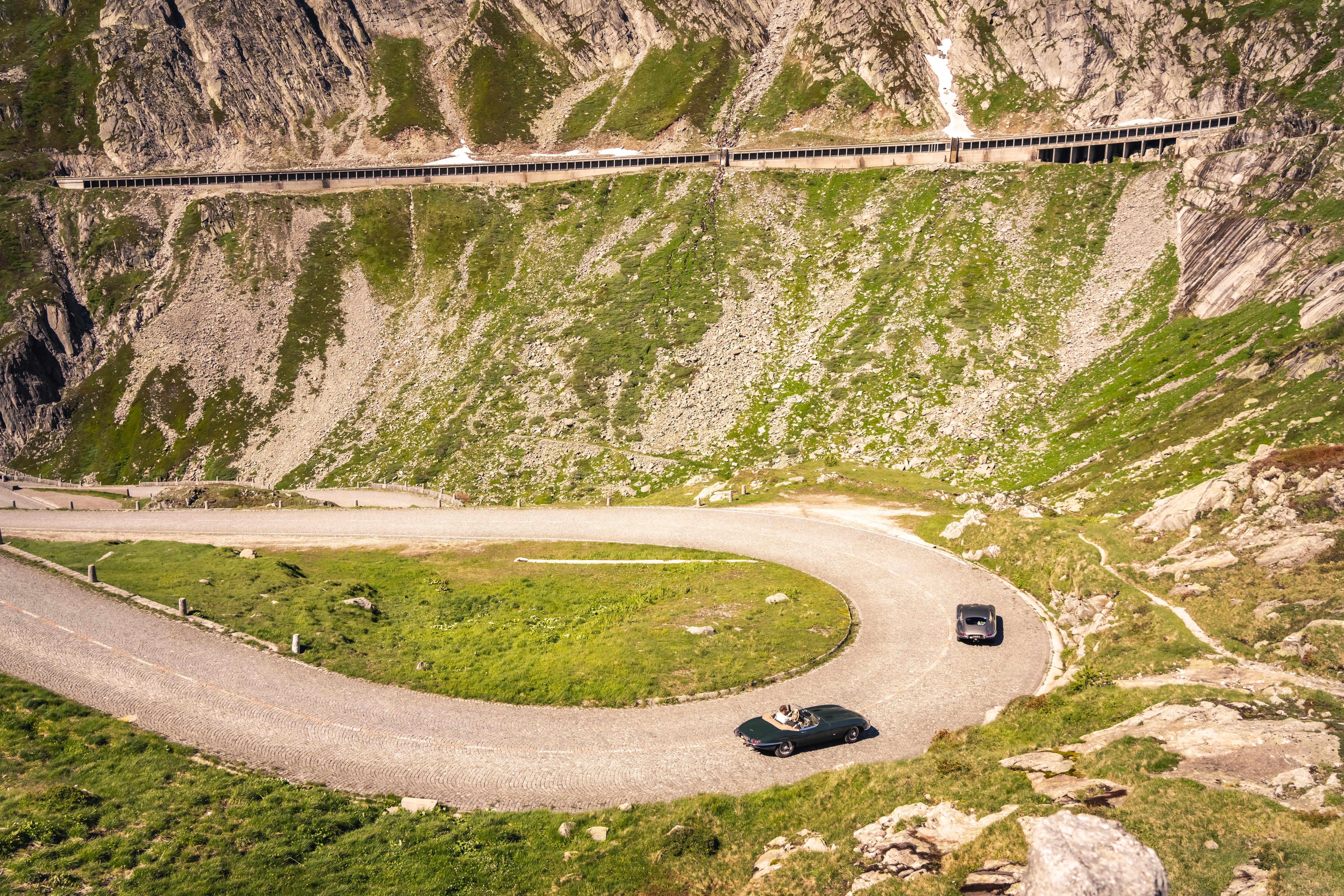 Jaguar E-Type on an alpine hairpin road in the Swiss Alps