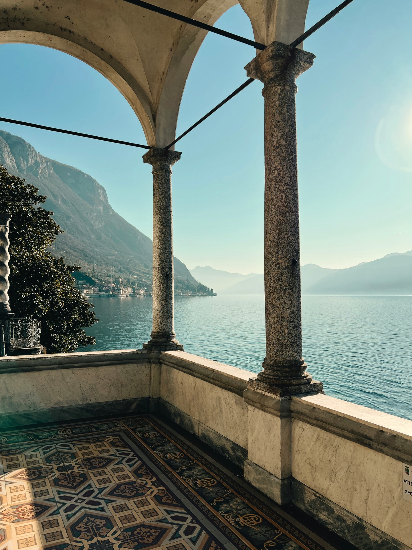 Villa del Balbianello loggia overlooking Lake Como — stone columns and mountain views