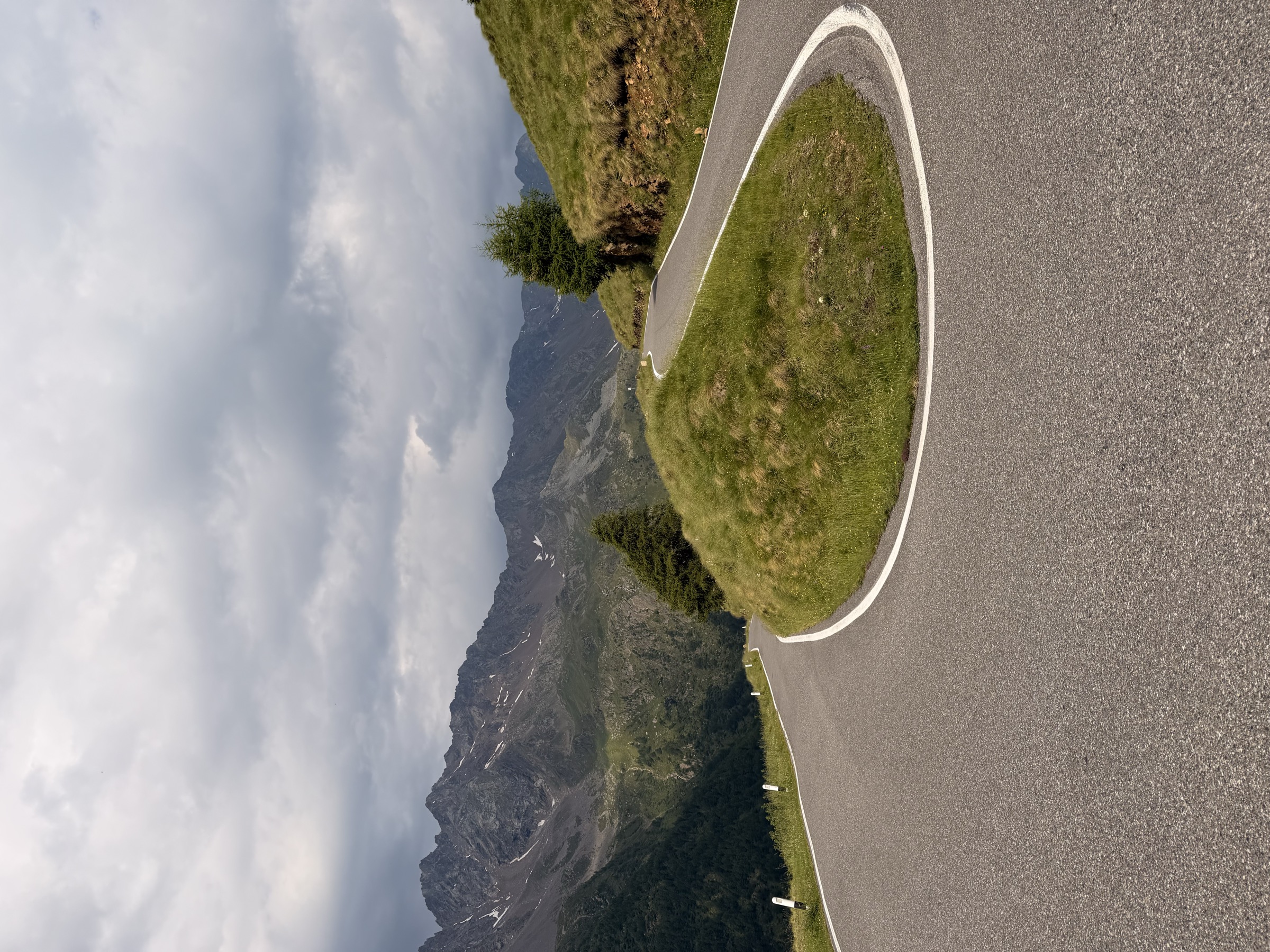 Narrow winding road climbing through the Passo Gavia with no barriers