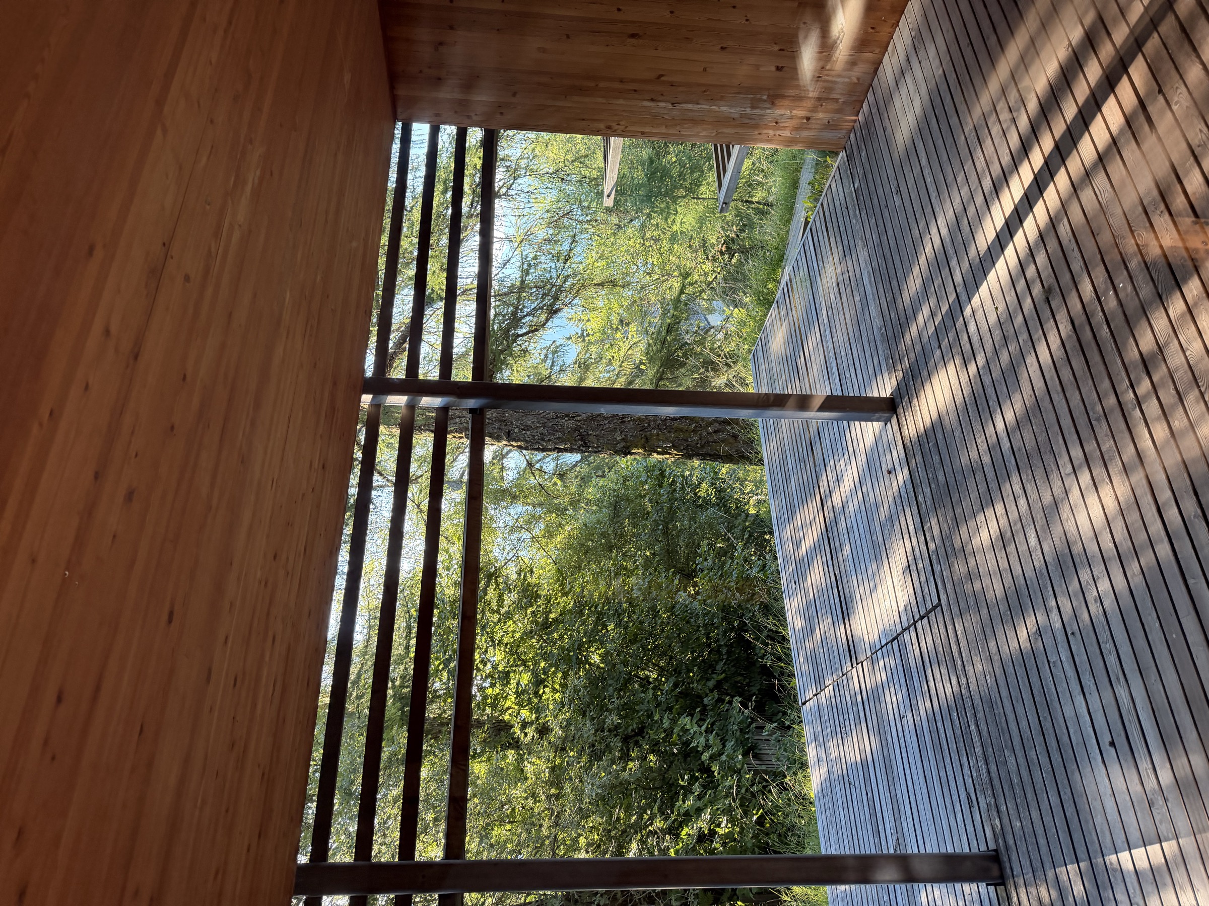 Wooden deck at Vigilius Mountain Resort opening onto the forest around San Vigilio